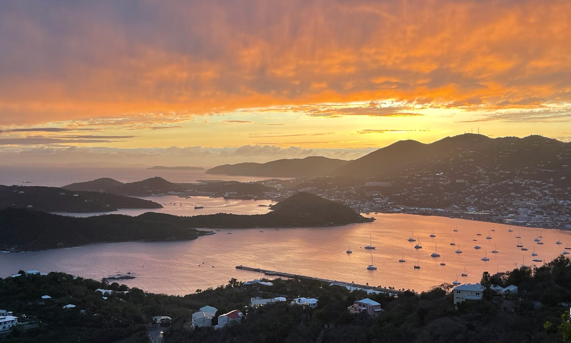 A beautiful city view with a sunset and a lake